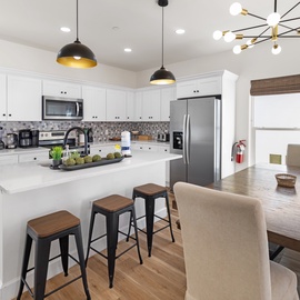 Step into your bright, modern kitchen where you'll love preparing meals at the spacious island and sharing stories over coffee. Natural light floods the space, making every moment here feel warm and inviting.