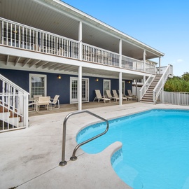 Two-story vacation home featuring a private swimming pool surrounded by spacious outdoor areas and tropical landscaping.