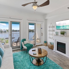 Relax in your bright coastal living room with stunning water views through French doors leading to your private balcony.