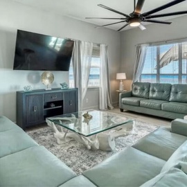 Unwind in your elegant living space with plush leather seating, modern amenities, and stunning ocean views.