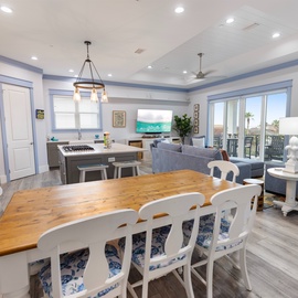 Gather around the live-edge dining table, cook in your bright kitchen, and relax in the living room—all in one open, airy space designed for your coastal getaway.