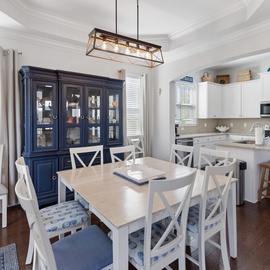 Gather around this bright dining area where family meals become cherished memories. The open-concept kitchen lets you prep and chat seamlessly, with granite counters, stainless appliances, and ample storage ready for your culinary adventures.