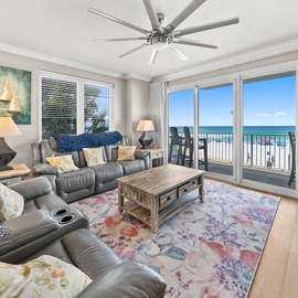 Wake up to stunning ocean views from your spacious living room, where leather seating and coastal decor create the perfect beach retreat.