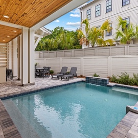 Slip into your private pool oasis surrounded by tropical palms and covered patio seating for the perfect Florida getaway.