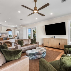Sink into plush velvet chairs and leather seating in your open-concept living space, where natural light flows through large windows.