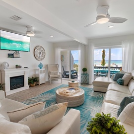 Your coastal retreat awaits in this bright living space where turquoise accents mirror the ocean beyond your balcony doors. Sink into plush seating and let sea breezes drift through as you unwind.