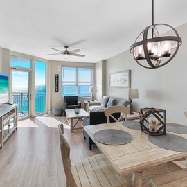 Your beachfront retreat features an open living and dining space with stunning ocean views through floor-to-ceiling windows, perfect for memorable seaside meals.