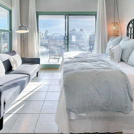 Sink into plush linens and wake to stunning mountain views from your bright, airy suite with cozy seating nook.