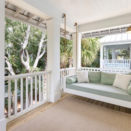 Sway gently on your private porch swing while tropical palms whisper overhead, creating your perfect outdoor retreat.