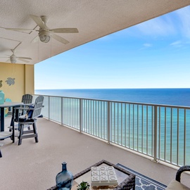 Your private oceanfront balcony awaits with comfortable seating and breathtaking sea views stretching to the horizon.