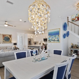Relax in your elegant dining room with stunning chandeliers, where you'll enjoy meals surrounded by beautiful coastal artwork and thoughtful décor.