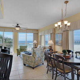 Relax in your elegant oceanfront living space where comfort meets coastal beauty through floor-to-ceiling windows.