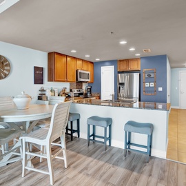You'll love this open kitchen and dining space with granite counters, stainless appliances, and breakfast bar seating—perfect for your morning coffee.