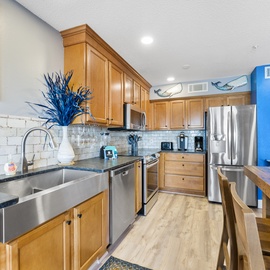 Your fully equipped kitchen features warm wood cabinets, granite counters, and stainless appliances for memorable home-cooked meals.