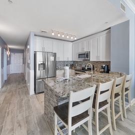 Your spacious kitchen features granite countertops, stainless steel appliances, and a breakfast bar where you'll enjoy morning coffee.