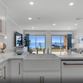 Your stunning oceanfront kitchen opens to breathtaking sea views, where cooking becomes pure joy with modern appliances and coastal elegance.