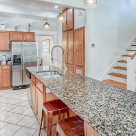 Your spacious gourmet kitchen features granite countertops, premium appliances, and a large island perfect for cooking memorable meals during your stay.