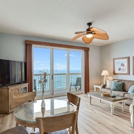 Relax in your coastal living room where ocean views greet you through floor-to-ceiling windows, while comfortable seating invites lazy afternoons.