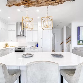 Your elegant kitchen features marble countertops, gold pendant lights, and flows seamlessly into the comfortable living space.