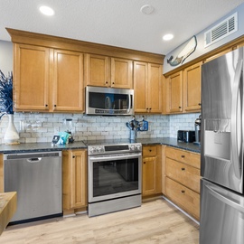 Your fully-equipped kitchen awaits with granite counters, stainless appliances, and everything needed to create memorable meals during your stay.