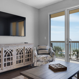 Relax in your bright living space with ocean views, cozy seating, and entertainment ready for your perfect beach getaway.