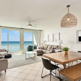 Wake up to endless ocean views from your beachfront living space, where coastal breezes flow through open doors to your private balcony.