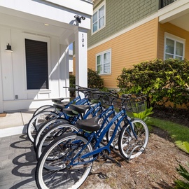 The property's bike fleet stands ready near the entrance, inviting you to explore the neighborhood at your own pace. Cruise along nearby paths or discover local spots with ease—your perfect seaside adventure awaits.