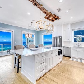 Your dream kitchen awaits with stunning ocean views, sleek white cabinetry, and modern appliances where you'll create memorable meals.