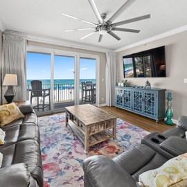 Unwind in your elegant beachfront living room where plush seating meets stunning ocean views through expansive windows.