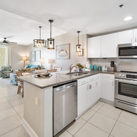 Your modern kitchen features granite counters, stainless appliances, and stylish pendant lighting—perfect for preparing vacation meals together.