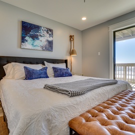 Sink into crisp linens and coastal-inspired decor in your serene retreat, with ocean breezes just beyond your private balcony.