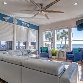 Sink into plush coastal comfort while tropical breezes flow through your bright living space with stunning ocean views.