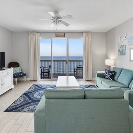 Sink into plush teal seating while ocean waves dance beyond your private balcony. Cool coastal breezes and endless sea views create your perfect retreat.