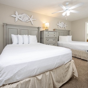 Rest peacefully in this inviting guest bedroom with two queen beds, stylish decor, and access to the bathroom