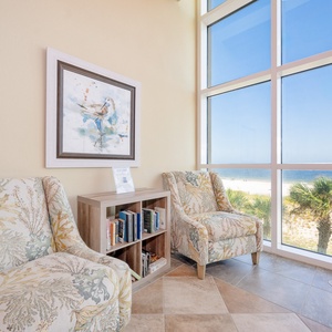 A cozy lobby nook with two comfortable chairs and a charming bookcase, perfect for relaxing with a good book