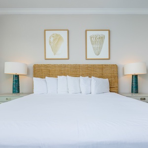 Sink into the plush king bed, letting the serene beach views wash over you as you unwind in tranquility