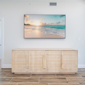 Enjoy the serene ambiance with a stylish TV mounted above a natural wood cabinet for streaming your favorite show