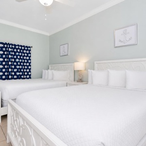 Drift into peaceful sleep in this guest suite with two queen beds offering restful calm after your day