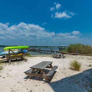 Discover the lagoon with kayaks ready and picnic tables for gatherings in this serene waterfront retreat at Summer House West