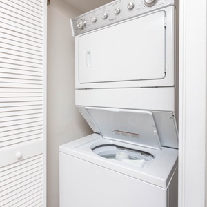 Washer and dryer combo tucked neatly in a closet, providing convenience for guests during their stay