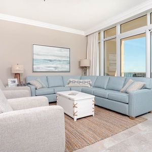 Relax in the airy living room, where soft furnishings invite cozy moments while the coastal views inspire tranquility