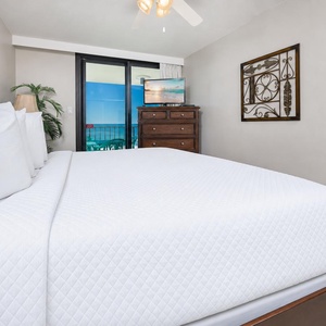Unwind and watch your favorite show as you relax with a gentle balcony breeze in this king master suite