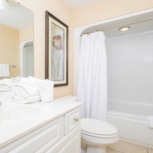 Refreshing guest bathroom featuring plush towels, a modern sink, and a relaxing tub/shower combo for your comfort