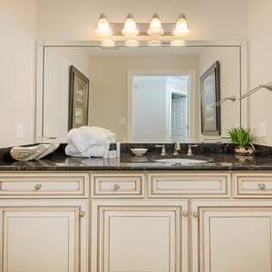 Additional guest half bath with soothing colors and soft towels for convenience during your stay