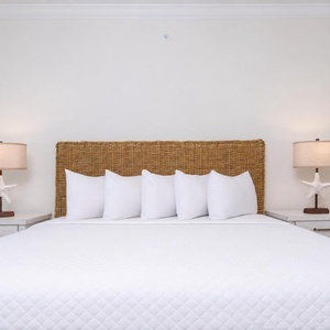 Experience restful nights in this king guest room featuring a large bed, fluffy pillows, and stylish bedside lamps