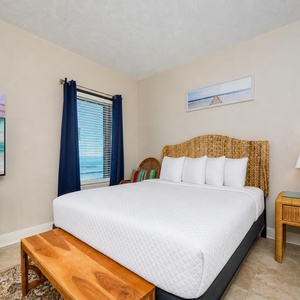 Embrace tranquility as you relax on your plush queen bed, soaking in coastal views that inspire restful dreams