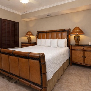 Experience comfort in this inviting master bedroom featuring a plush king bed, elegant decor, and warm lighting