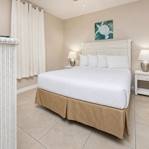 Sleep soundly in this inviting guest bedroom with a plush queen bed, soft linens, and charming coastal artwork