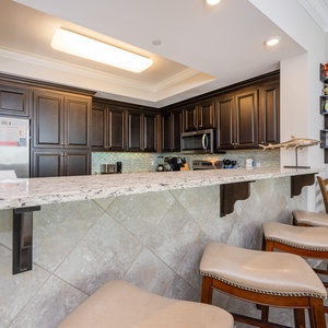 Wake up with morning coffee at the breakfast bar and get ready for a beach day in this stylish space