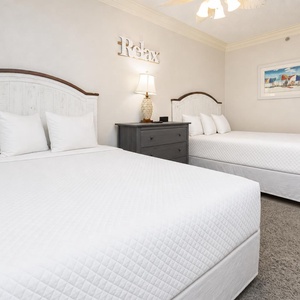 Two double beds in the guest suite invite restful nights surrounded by calm coastal decor and gentle hues